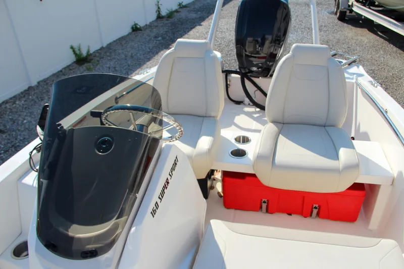Slide: The Image of 2022 Boston Whaler 160 Super Sport boat interior with seating and console. - 13