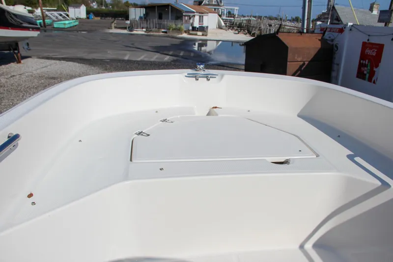 Slide: The Image of 2022 Boston Whaler 160 Super Sport boat interior at a dockside location. - 17