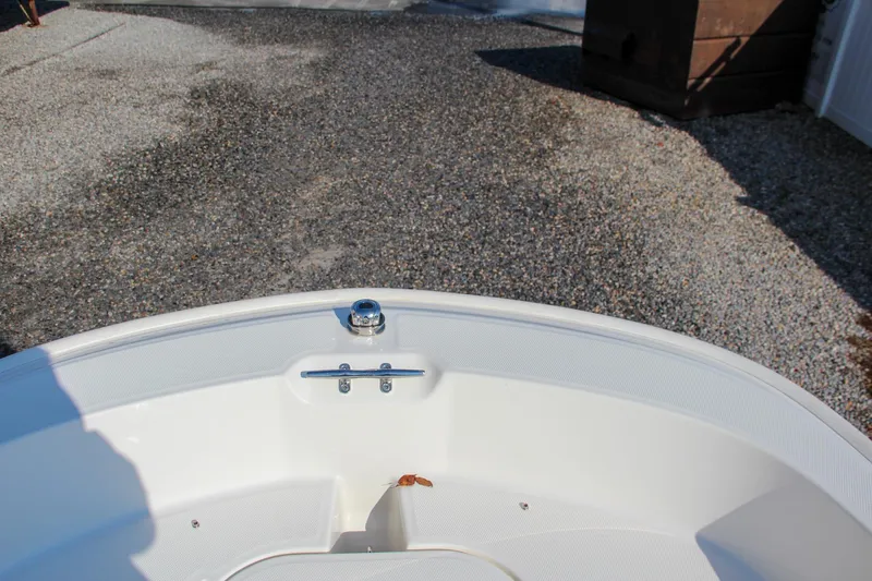 Slide: The Image of 2022 Boston Whaler 160 Super Sport bow detail on gravel surface. - 18