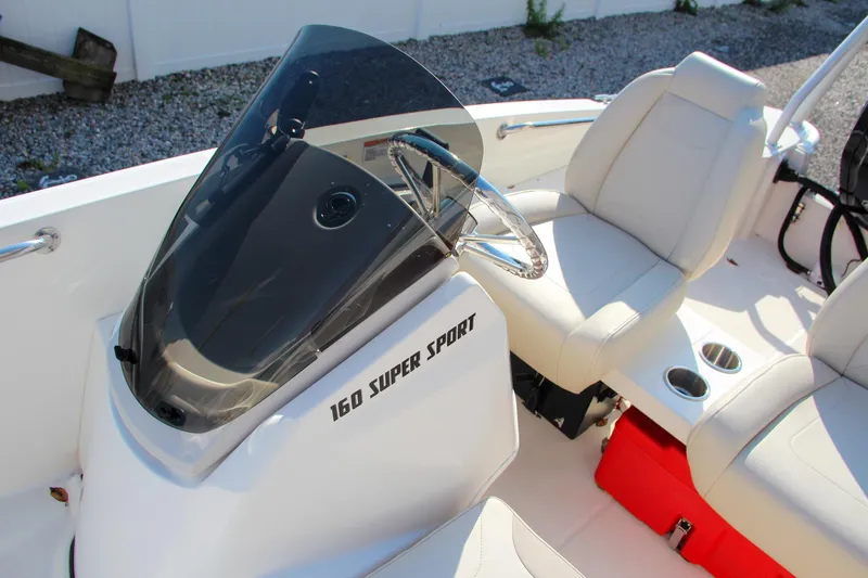 Slide: The Image of 2022 Boston Whaler 160 Super Sport boat interior with steering console and seating. - 19