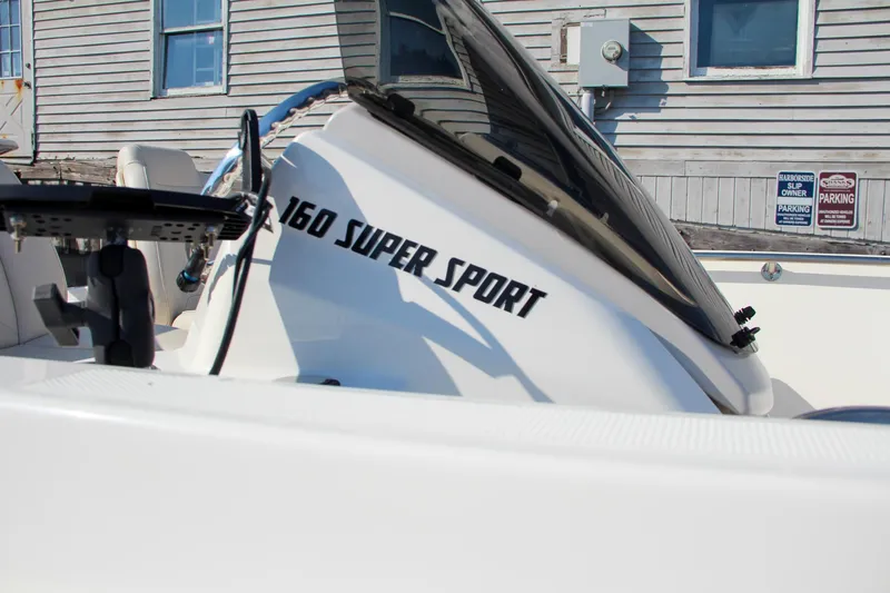 Slide: The Image of 2022 Boston Whaler 160 Super Sport boat side view with windshield. - 2