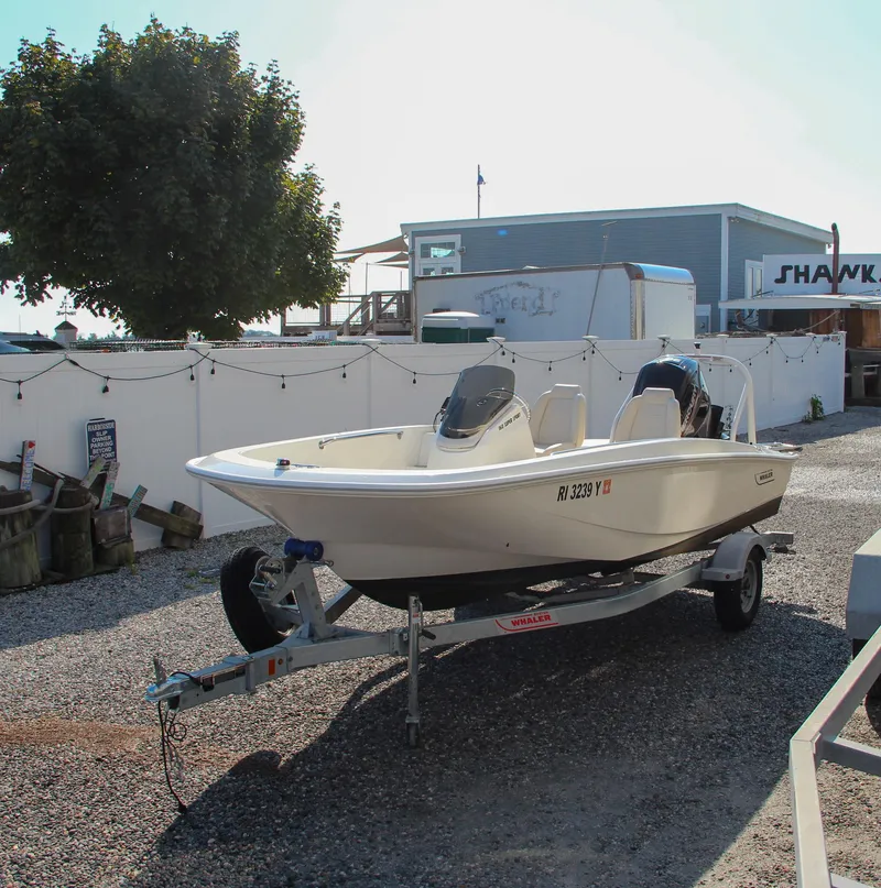 Slide: The Image of 2022 Boston Whaler 160 Super Sport boat on trailer in sunny outdoor setting. - 3