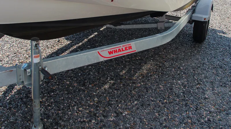 Slide: The Image of 2022 Boston Whaler 160 Super Sport trailer on gravel surface. - 5
