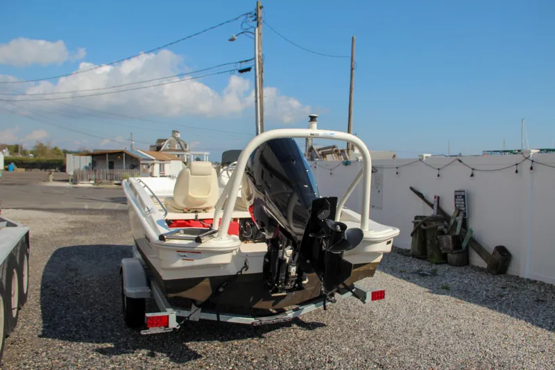 Slide: The Image of 2022 Boston Whaler 160 Super Sport boat on trailer, parked outdoors. - 7