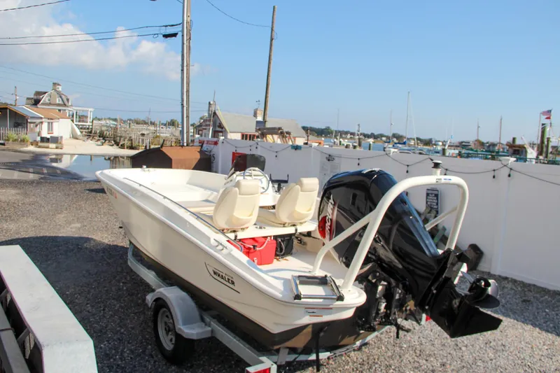 Slide: The Image of 2022 Boston Whaler 160 Super Sport boat on trailer at marina. - 8