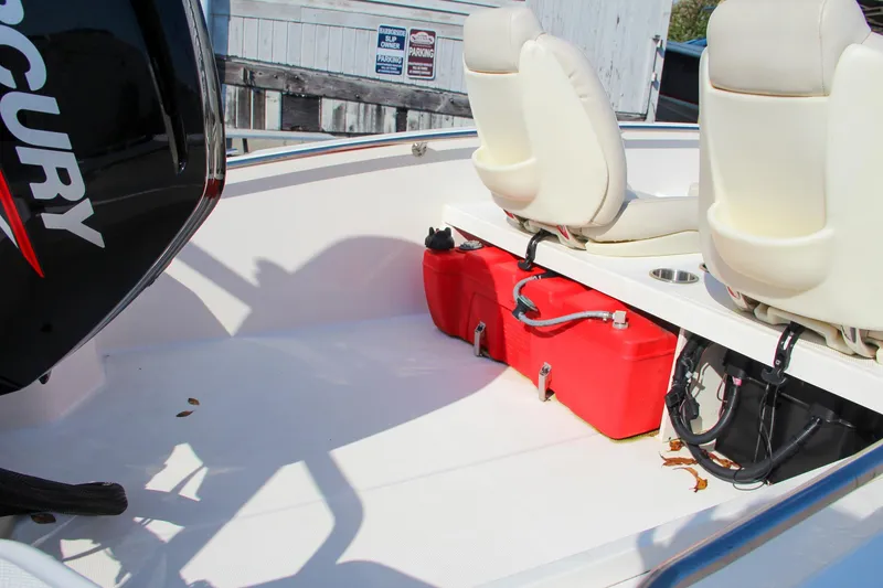 Slide: The Image of 2022 Boston Whaler 160 Super Sport boat interior with red fuel tank and white seats. - 9
