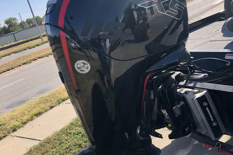 Slide: The Image of 2023 Ranger RT188P boat engine, black with red accents, parked on roadside. - 14