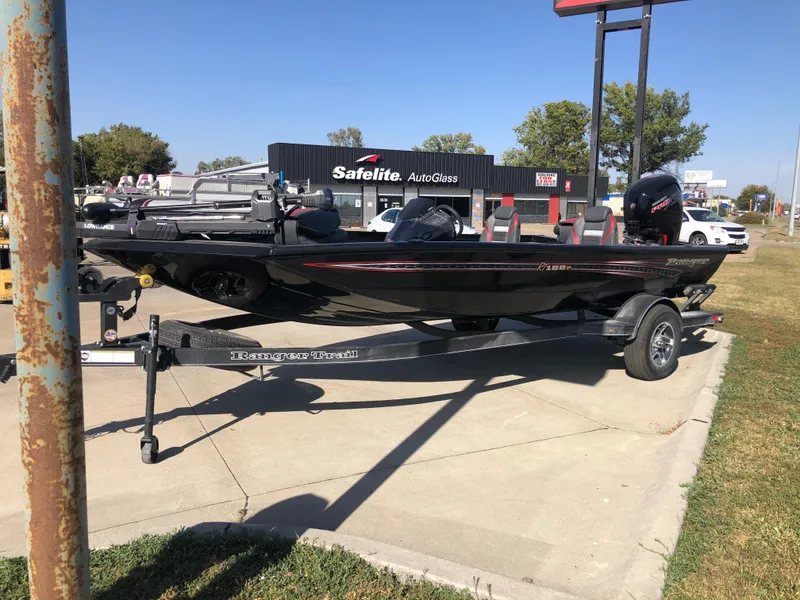 Slide: The Image of 2023 Ranger RT188P boat on trailer in parking lot, near Safelite AutoGlass. - 2
