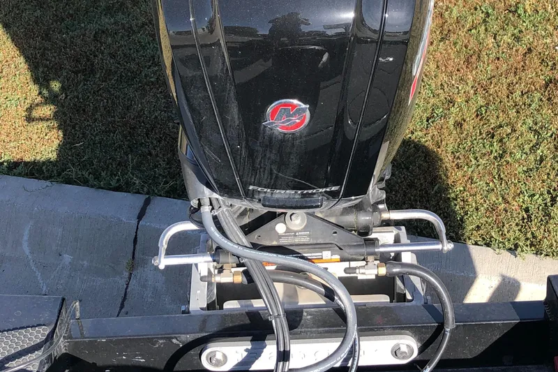 Slide: The Image of 2023 Ranger RT188P boat engine, black with red logo, parked on grass. - 6