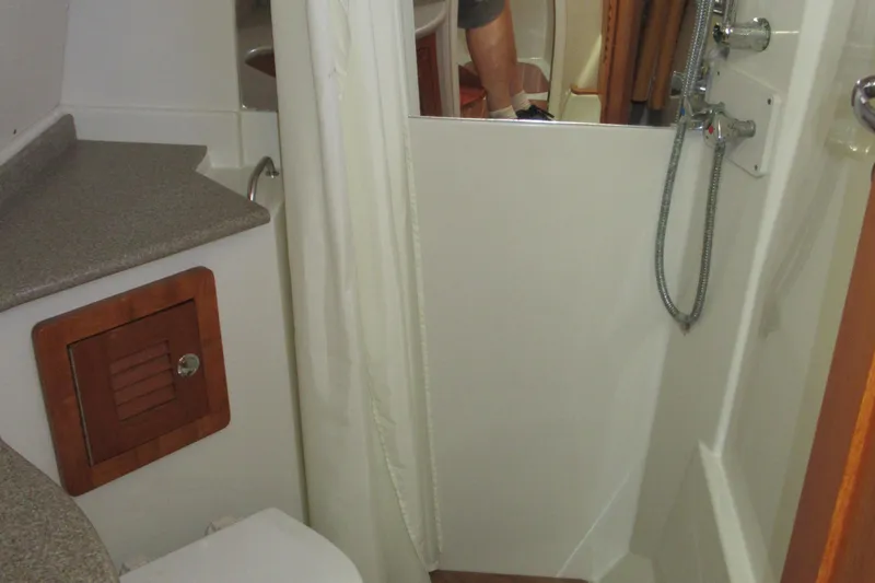 Slide: The Image of Compact bathroom in 2006 Glacier Bay 3470 Ocean Runner boat with shower and storage. - 10