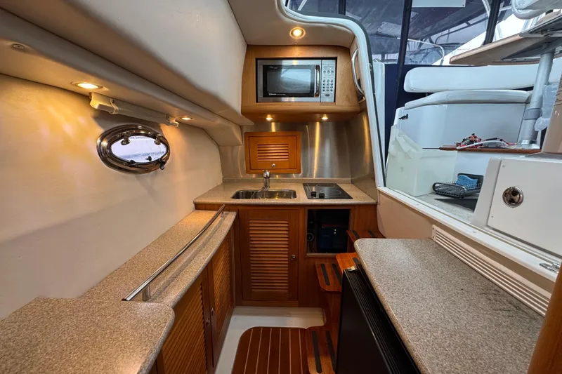 Slide: The Image of 2006 Glacier Bay 3470 Ocean Runner yacht kitchen with microwave, sink, and stove. - 12