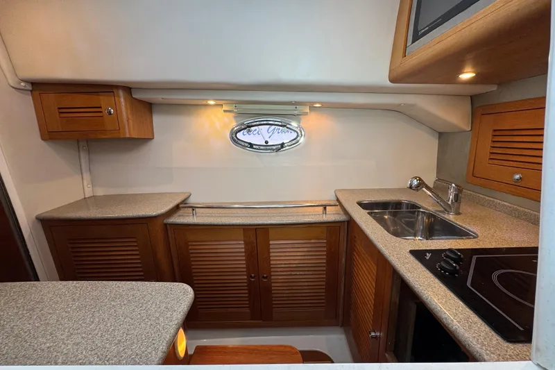 Slide: The Image of 2006 Glacier Bay 3470 Ocean Runner boat kitchen with wooden cabinets and modern appliances. - 14