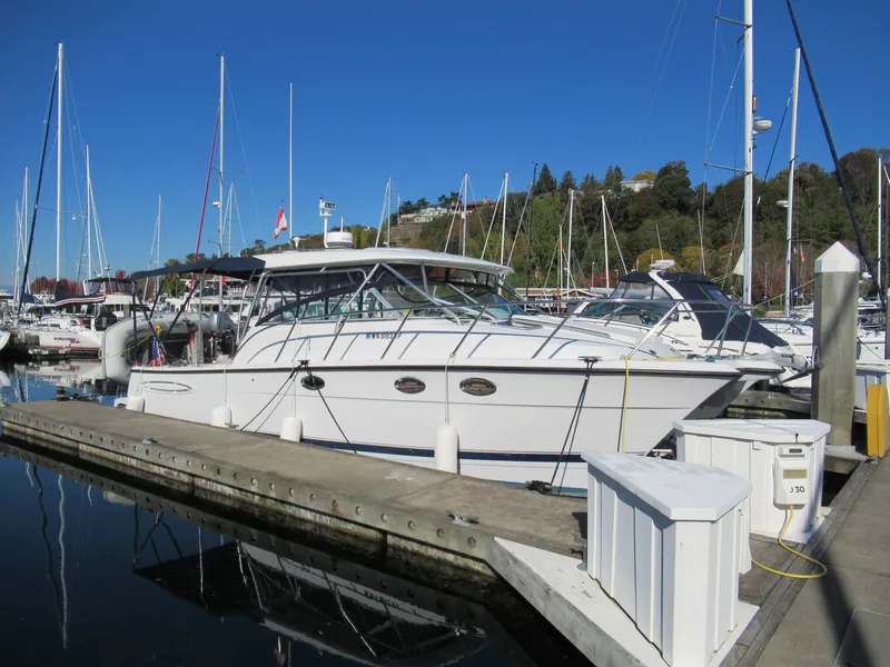 Slide: The Image of 2006 Glacier Bay 3470 Ocean Runner docked at a marina under clear blue skies. - 2