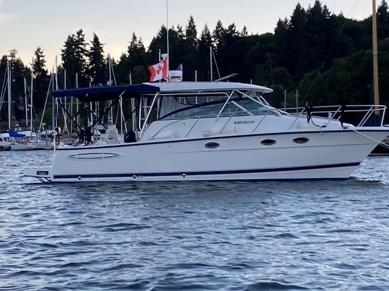 Slide: The Image of 2006 Glacier Bay 3470 Ocean Runner boat on water near marina and forest. - 20