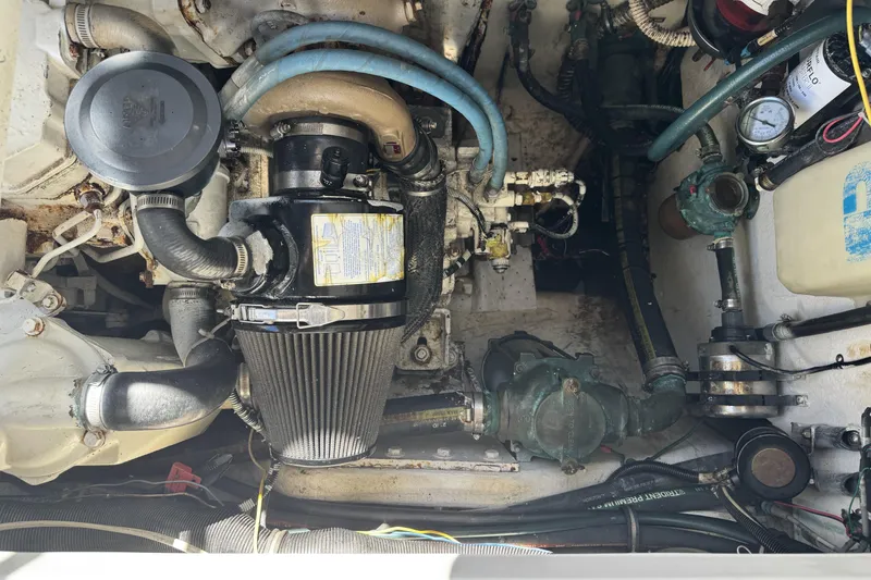 Slide: The Image of Engine compartment of a 2006 Glacier Bay 3470 Ocean Runner, showcasing mechanical components and hoses. - 22