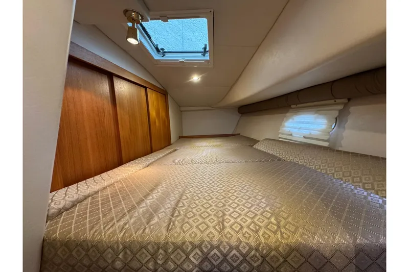 Slide: The Image of 2006 Glacier Bay 3470 Ocean Runner cabin interior with cozy bed and wooden accents. - 8