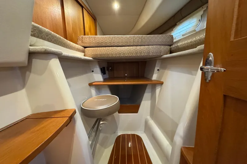 Slide: The Image of 2006 Glacier Bay 3470 Ocean Runner cabin interior with wooden accents and seating. - 9