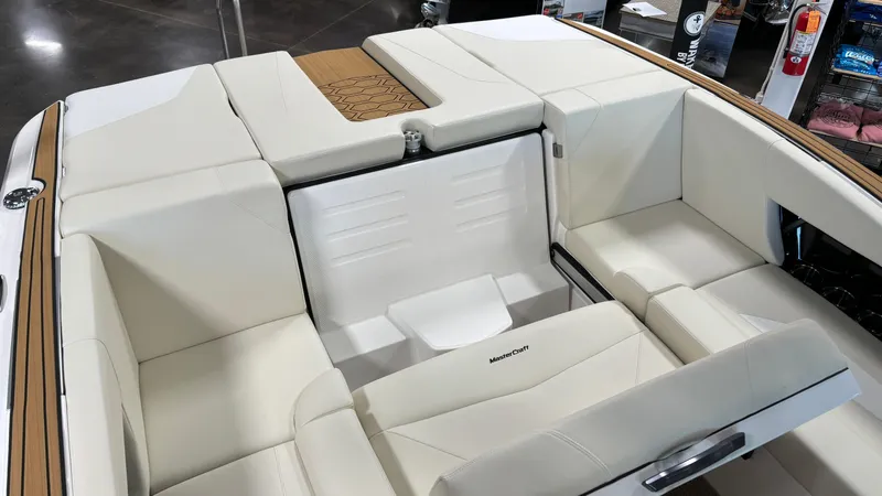 Slide: The Image of 2025 MasterCraft NXT23 boat interior with white seating and modern design. - 15
