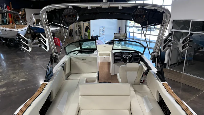 Slide: The Image of 2025 MasterCraft NXT23 boat interior with white seating and modern dashboard. - 16