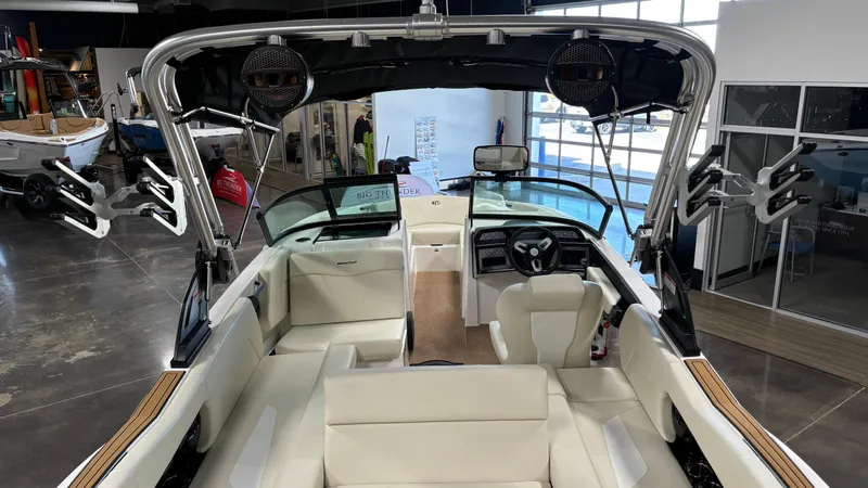 Slide: The Image of 2025 MasterCraft NXT23 boat interior with white seating and modern dashboard. - 17