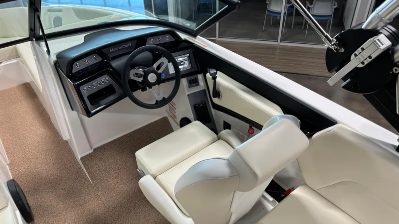 Slide: The Image of 2025 MasterCraft NXT23 boat interior with modern dashboard and comfortable seating. - 19