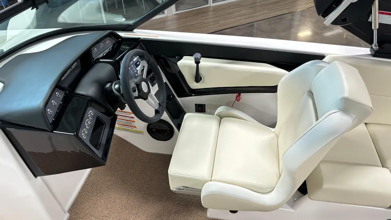 Slide: The Image of 2025 MasterCraft NXT23 boat interior with sleek dashboard and comfortable seating. - 20