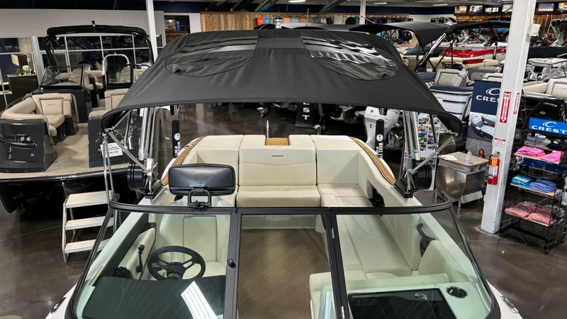 Slide: The Image of 2025 MasterCraft NXT23 boat interior with canopy in showroom. - 30