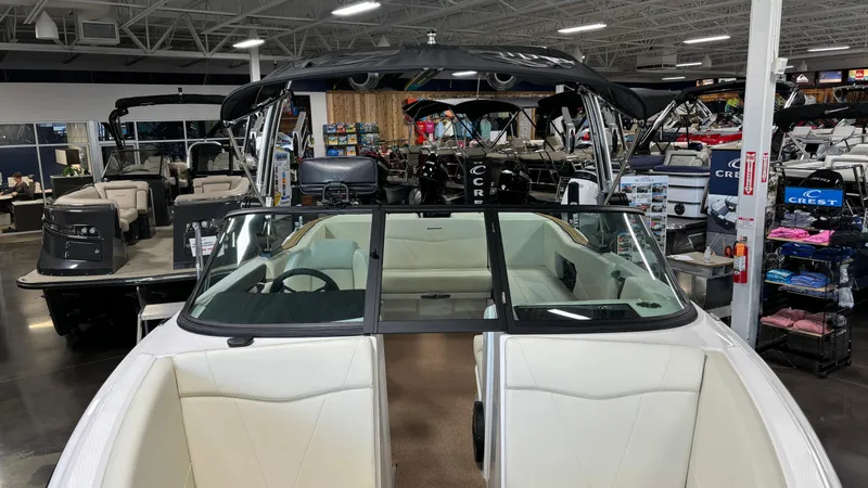 Slide: The Image of 2025 MasterCraft NXT23 boat displayed in a showroom with other boats. - 33