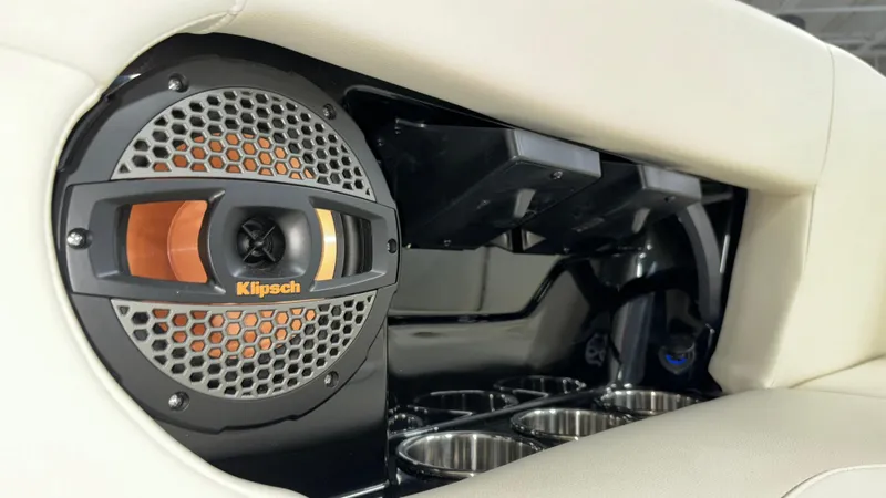 Slide: The Image of Klipsch speaker and cup holders in 2025 MasterCraft NXT23 boat interior. - 34
