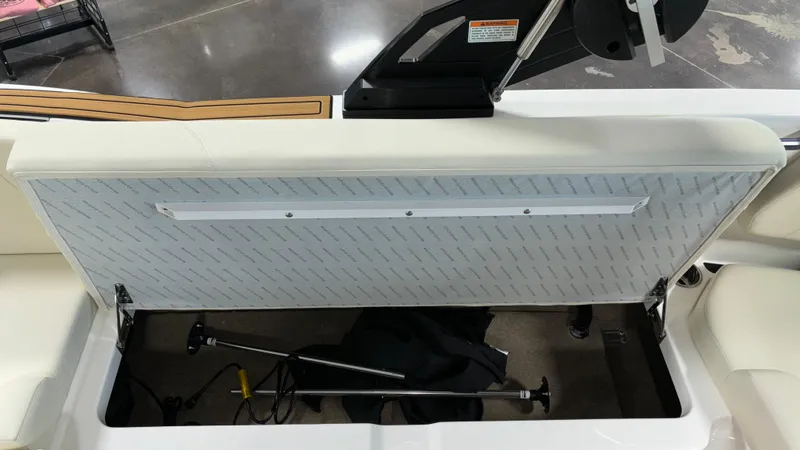 Slide: The Image of 2025 MasterCraft NXT23 boat storage compartment with open lid, revealing interior space. - 37