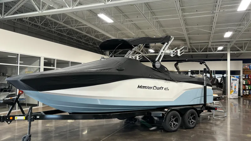 Slide: The Image of 2025 MasterCraft NXT23 boat in showroom, covered and on trailer. - 40