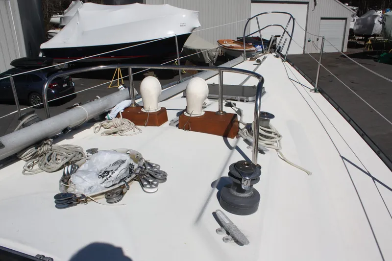 Slide: The Image of 1976 C&C 38 sailboat deck with winches and ropes in a marina setting. - 11