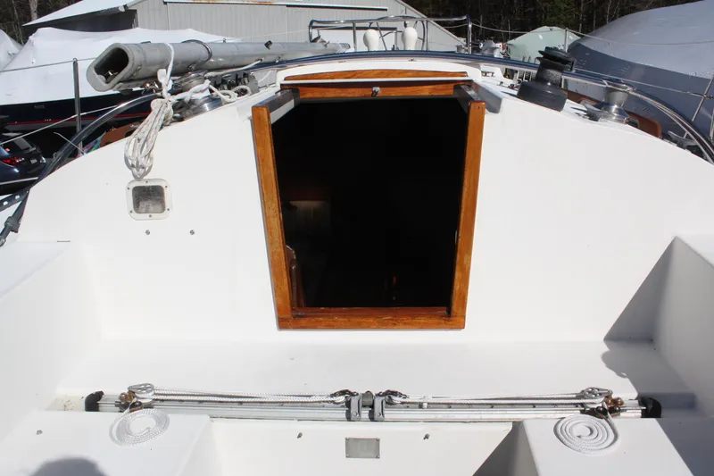 Slide: The Image of 1976 C&C 38 sailboat cockpit with open cabin entrance and visible rigging. - 15