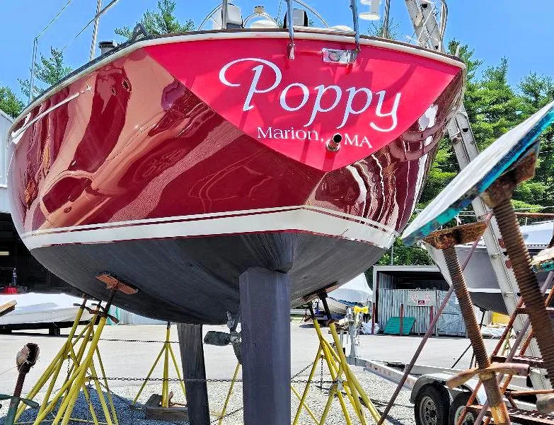 Slide: The Image of Red C&C 38 sailboat named "Poppy" in a boatyard, Marion, MA, 1976 model. - 2
