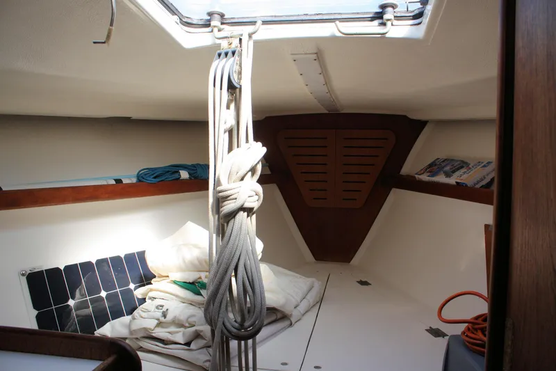 Slide: The Image of Interior of a 1976 C&C 38 sailboat with ropes and storage shelves. - 24