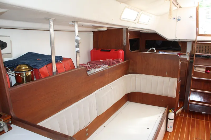 Slide: The Image of Interior of a 1976 C&C 38 sailboat with wood paneling and seating area. - 34