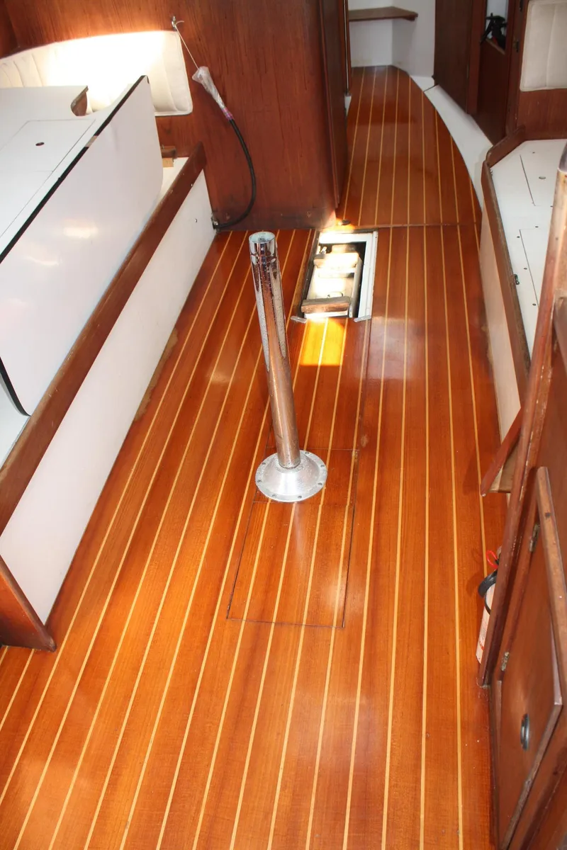 Slide: The Image of 1976 C&C 38 sailboat interior with polished wooden flooring and sleek design. - 37