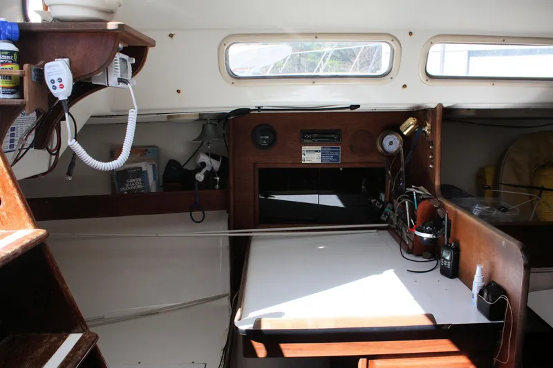 Slide: The Image of Interior of a 1976 C&C 38 sailboat, featuring navigation equipment and wooden cabinetry. - 40