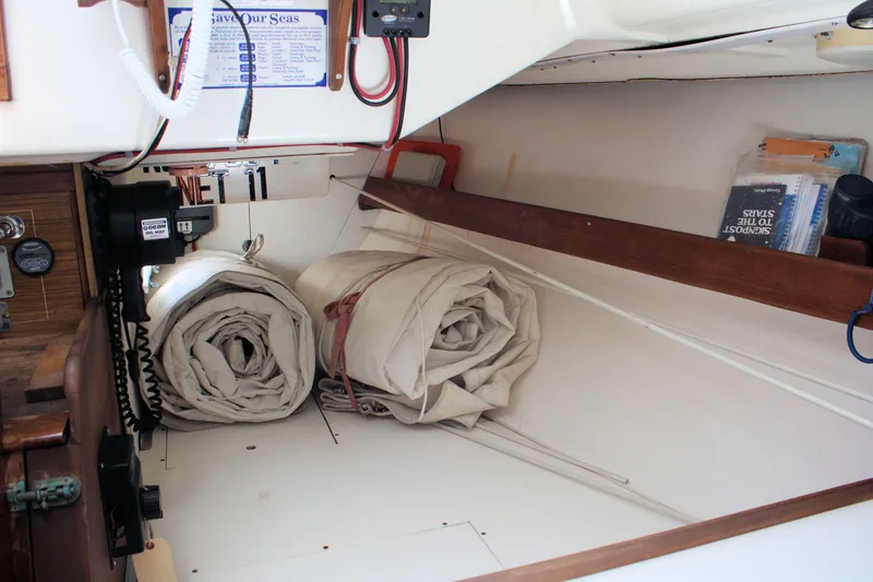 Slide: The Image of Interior of a 1976 C&C 38 sailboat with neatly stored sails and navigation equipment. - 41