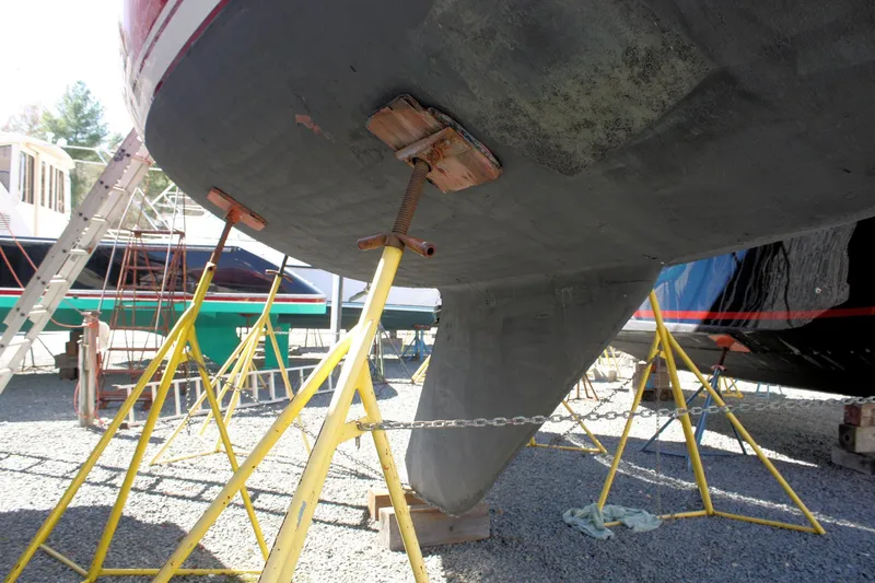 Slide: The Image of 1976 C&C 38 sailboat hull supported by yellow stands in a boatyard. - 7