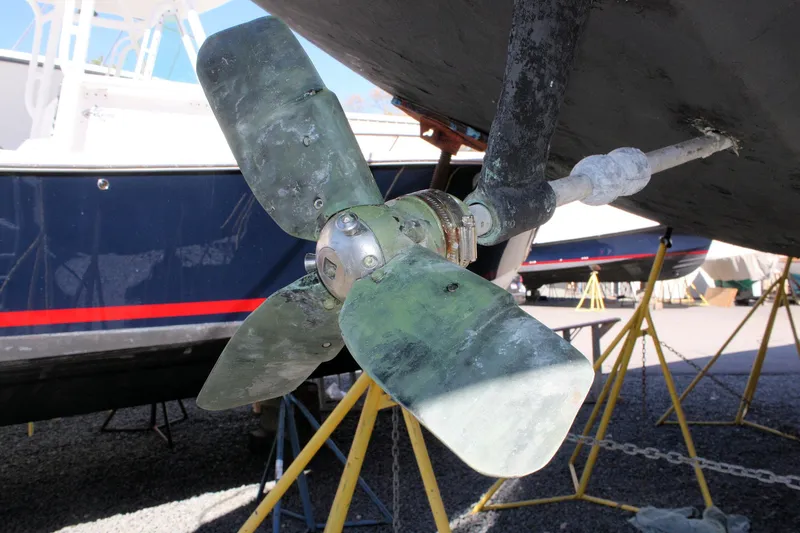 Slide: The Image of Propeller of a 1976 C&C 38 sailboat on dry dock, showing wear and marine growth. - 8