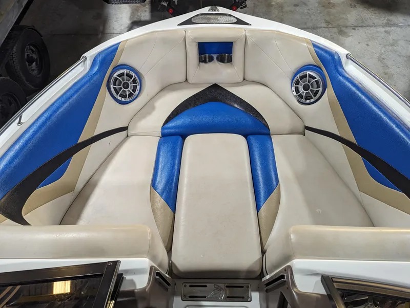 Slide: The Image of 2014 Centurion Enzo SV233 boat interior with blue and beige seating and built-in speakers. - 16