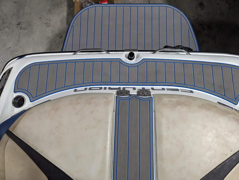 Slide: The Image of 2014 Centurion Enzo SV233 boat deck with blue-accented gray padding. - 20