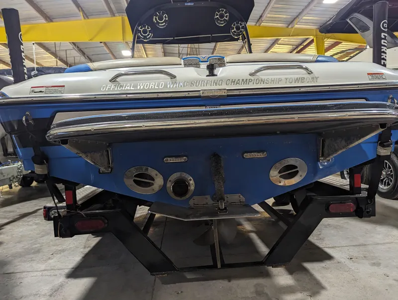 Slide: The Image of 2014 Centurion Enzo SV233 boat in storage, rear view, showcasing championship towboat branding. - 22