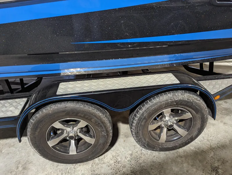 Slide: The Image of 2014 Centurion Enzo SV233 boat trailer with dual wheels and blue accents. - 24