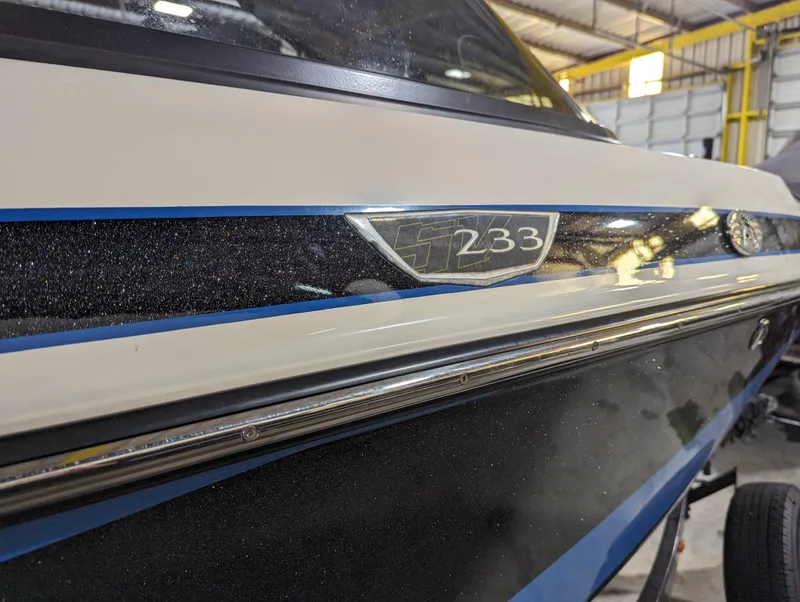 Slide: The Image of 2014 Centurion Enzo SV233 boat in a garage, showcasing sleek design and detailing. - 25