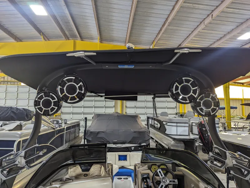 Slide: The Image of 2014 Centurion Enzo SV233 boat with speakers, stored indoors, showcasing sleek design and modern features. - 8