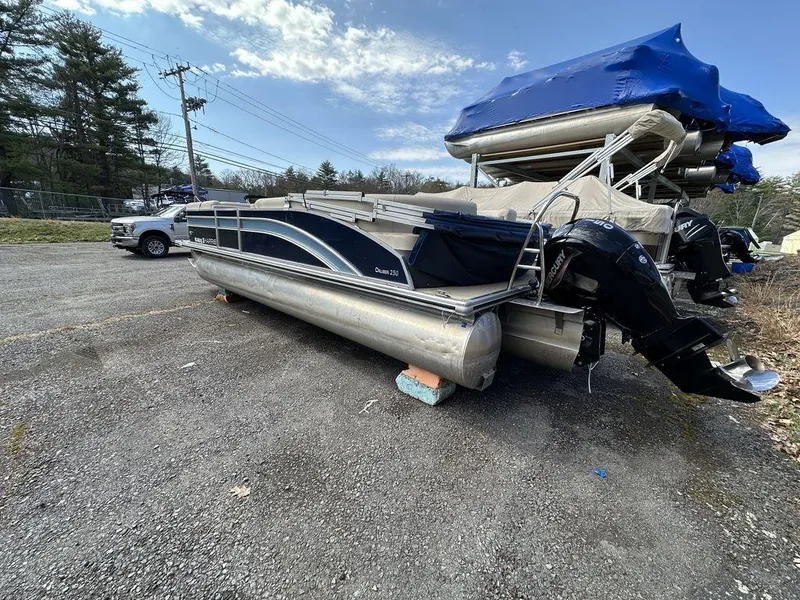 Slide: The Image of 2021 Harris CRUISER 250 CW P3 pontoon boat parked outdoors. - 16