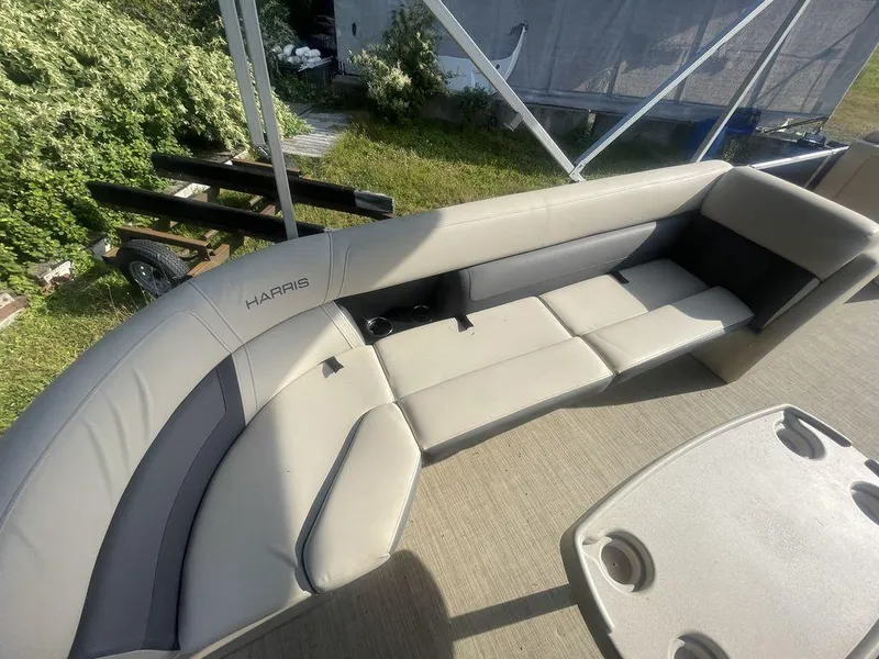 Slide: The Image of 2021 Harris CRUISER 250 CW P3 boat interior with beige seating and cup holders. - 3