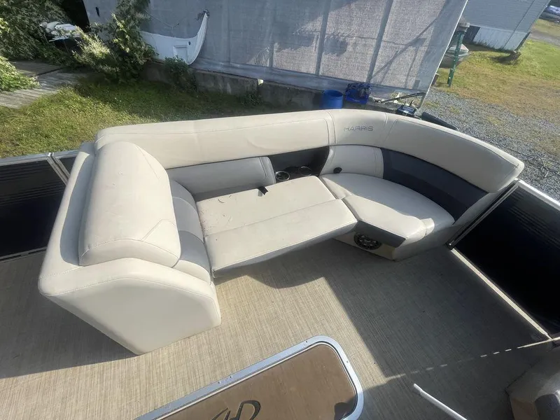 Slide: The Image of 2021 Harris CRUISER 250 CW P3 boat interior with beige seating and spacious layout. - 4